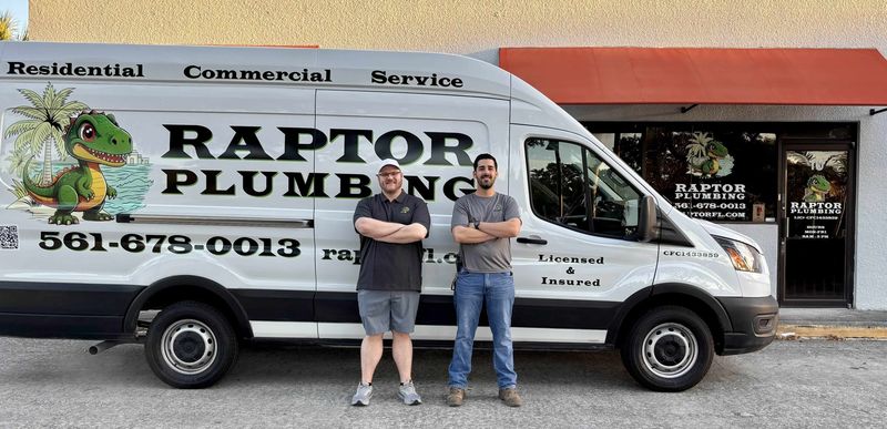 Two Raptor Plumbing team members standing in front of a Raptor Plumbing work van and the company storefront